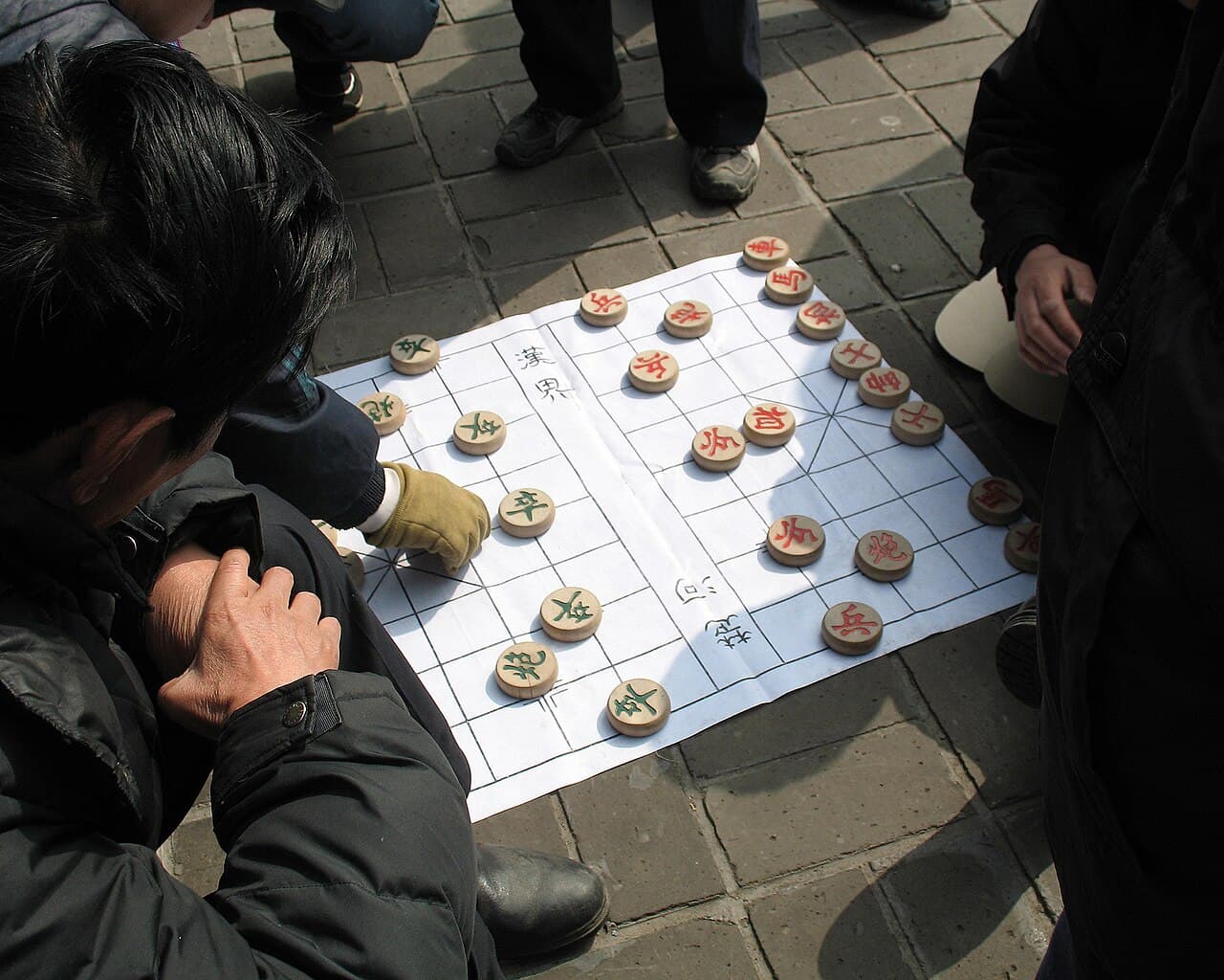 People playing xiangqi outdoors